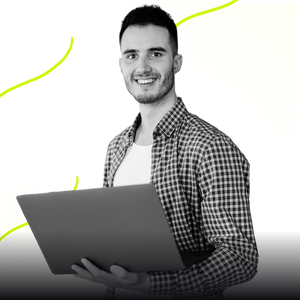 A marketer designing an email campaign on a laptop with analytics, automation workflows, and subscriber data displayed.