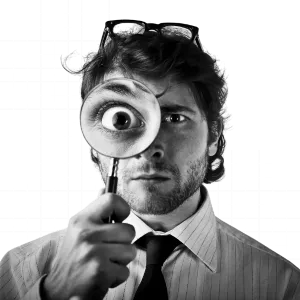 A product development team brainstorming concepts and reviewing prototypes with sketches, wireframes, and design notes on a table.